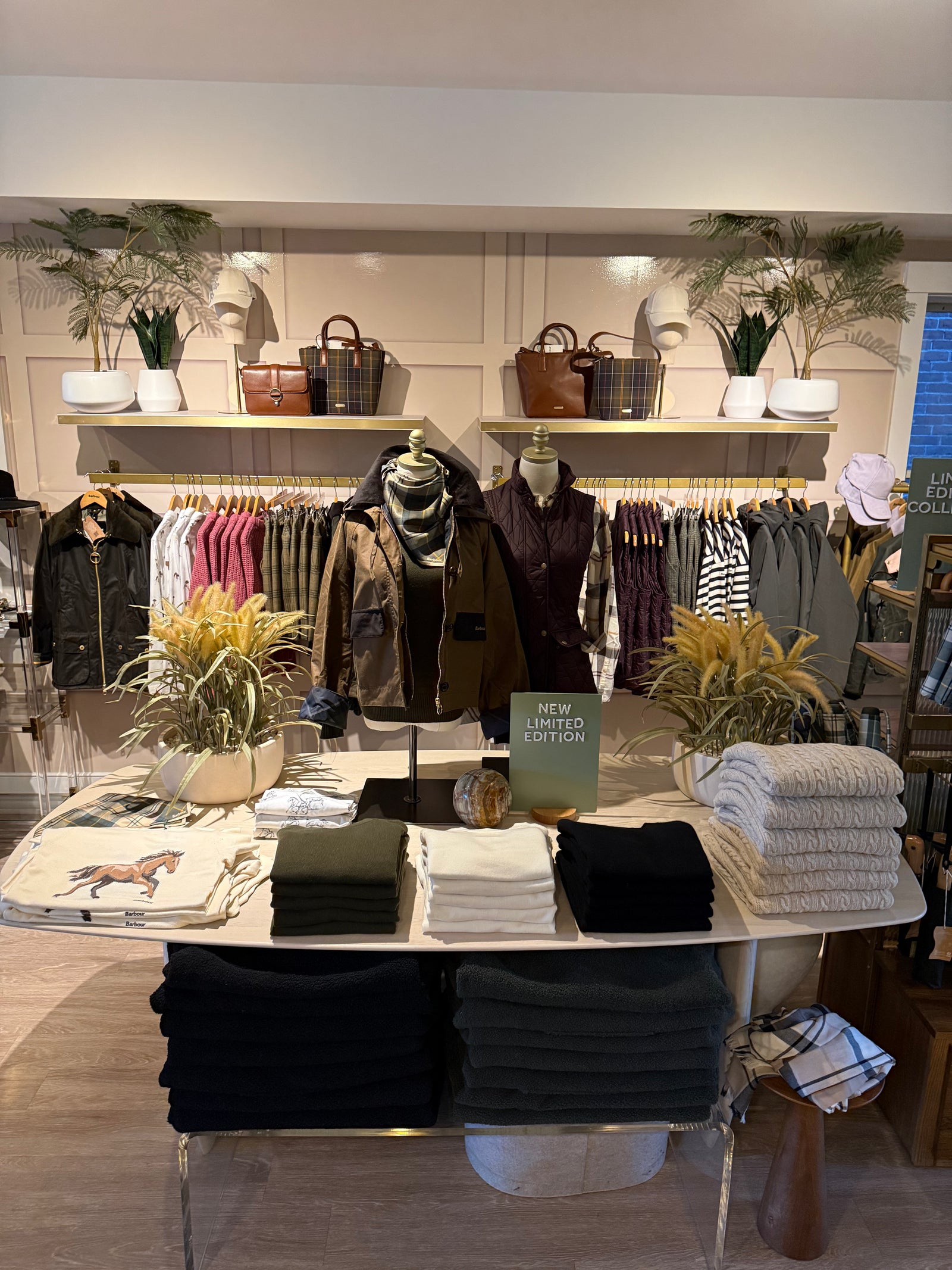 Inside New England Mercantile on Water Street in Exeter, with Barbour jackets, knitwear and bags